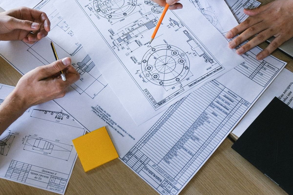 Engineers reviewing plans and documents together on a table