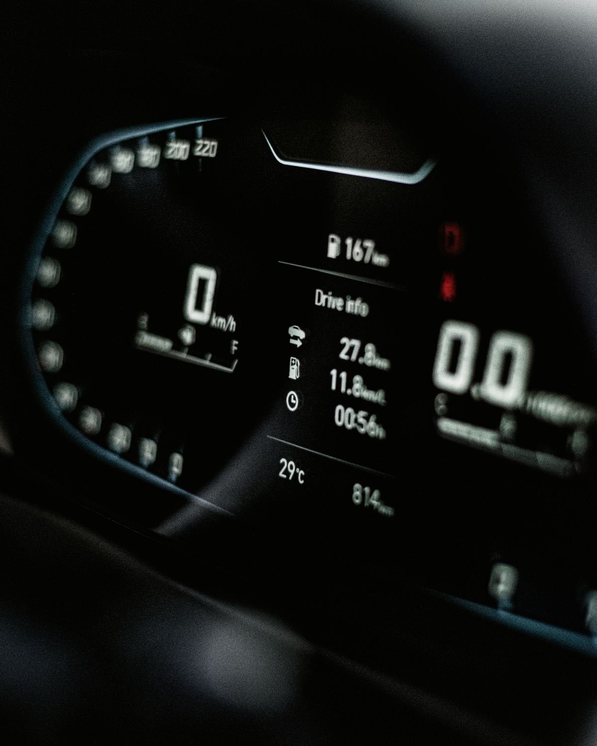 A close-up of a digital car dashboard showing speed and drive information