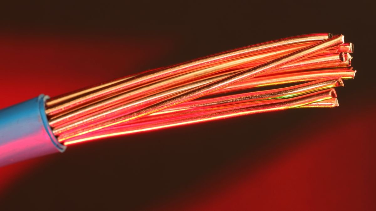 Close-up of a stranded copper conductor emerging from its insulation, showing cross-sectional area