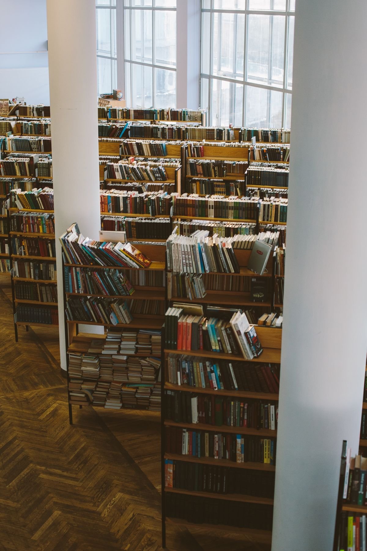 Rows of wooden bookshelves in a large library