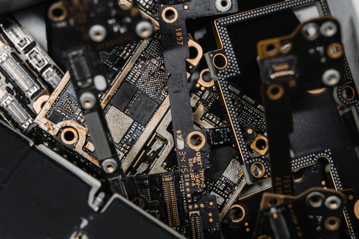 Assorted circuit boards and electronic components stacked together in macro detail