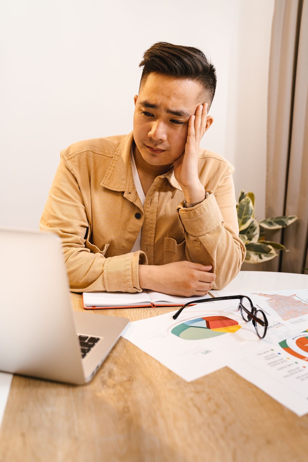 A frustrated engineer sitting at a laptop, illustrating problems with AI CAD software
