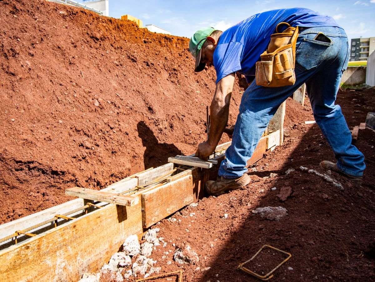 A construction worker building a reinforced concrete foundation on site
