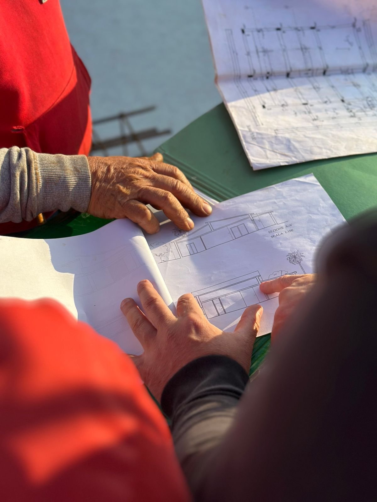 Team of engineers reviewing blueprints together in an office