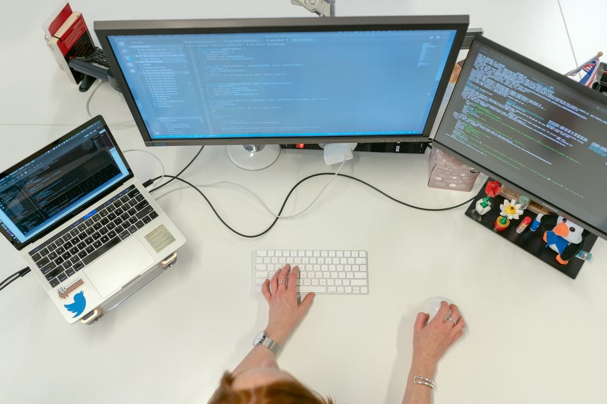 An engineer searching a material properties database on a dual-monitor workstation