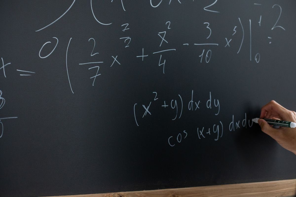 Mathematical equations written across a blackboard for a calculus lesson